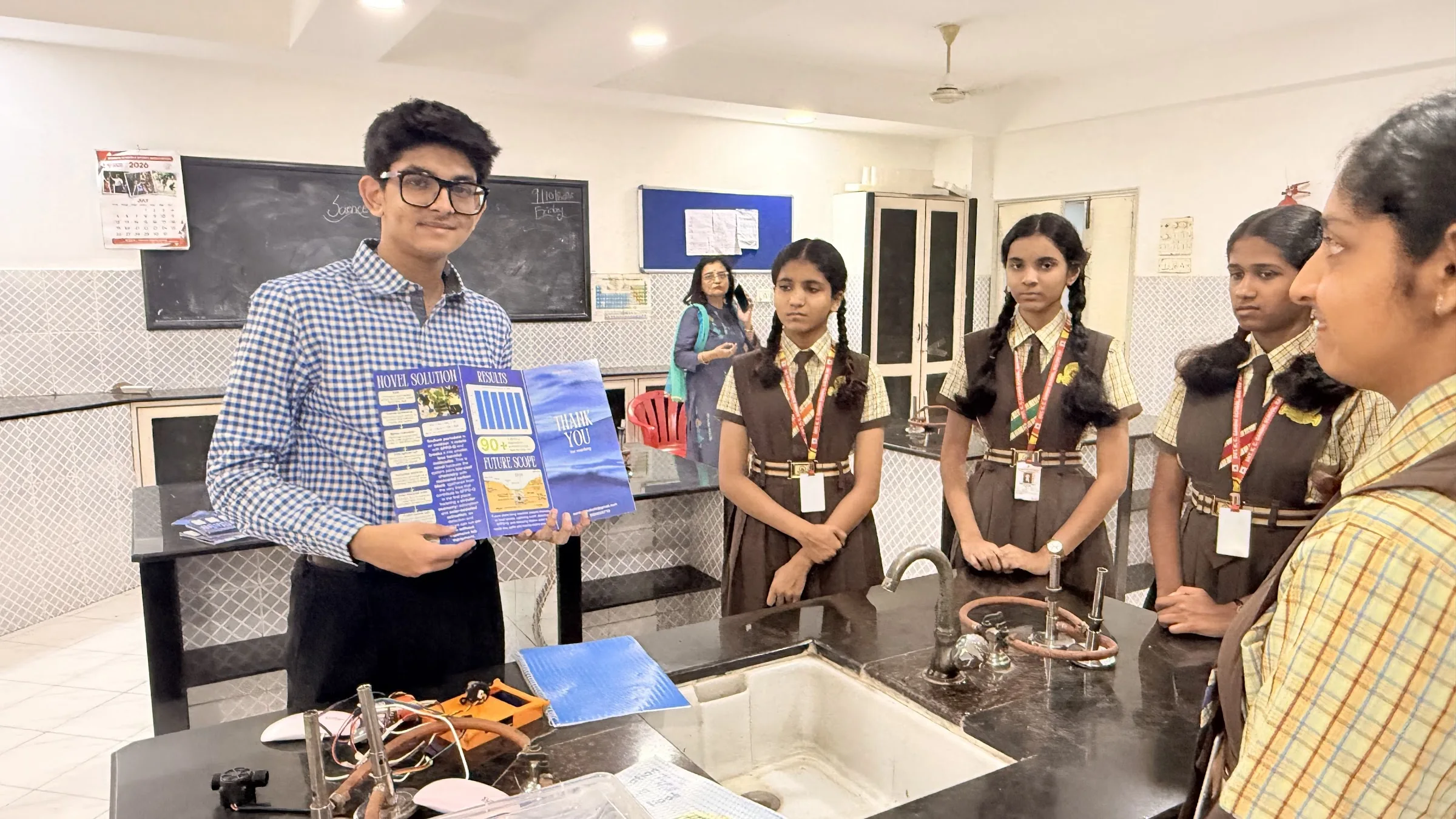 Aarav explaining the demonstration to a group of students