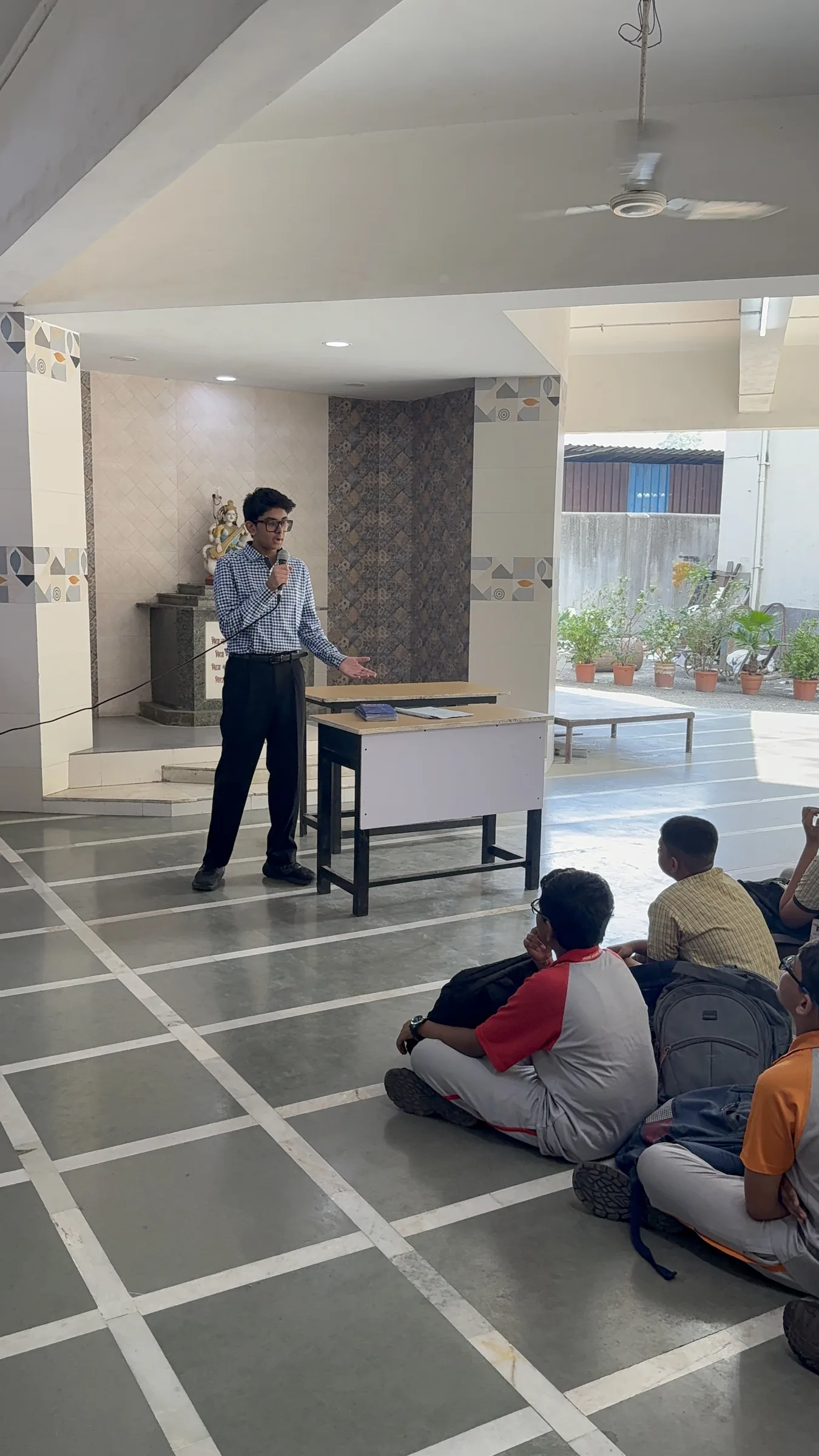 Aarav leading a small group discussion with students