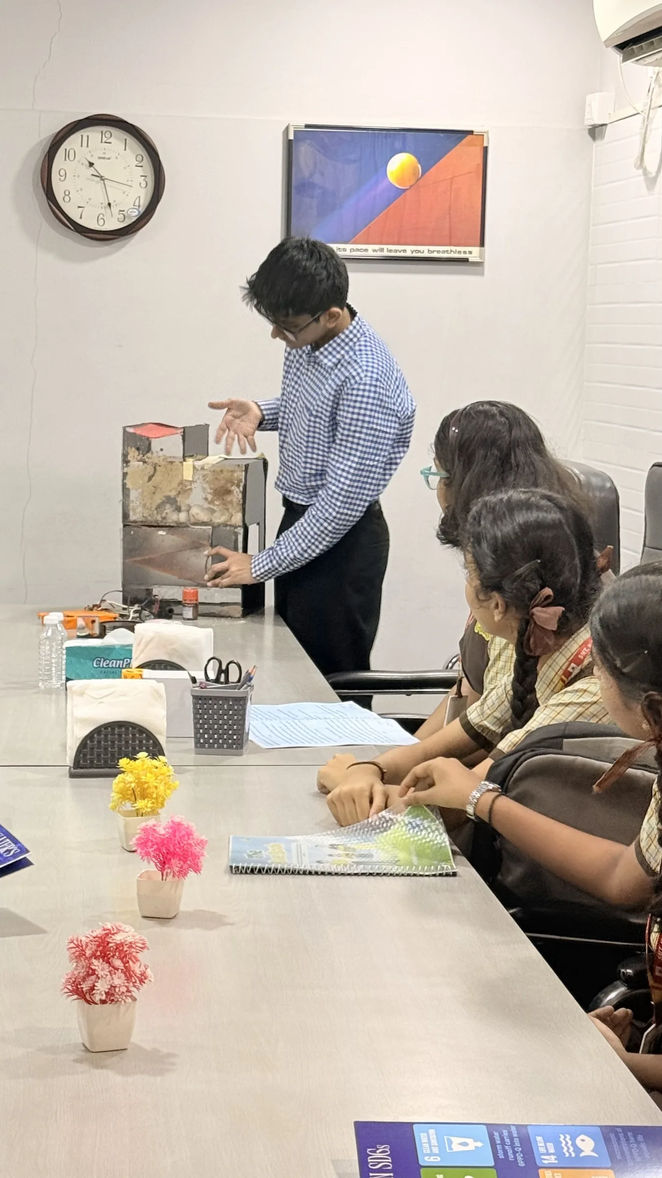 Students reviewing booklets together at a workshop table