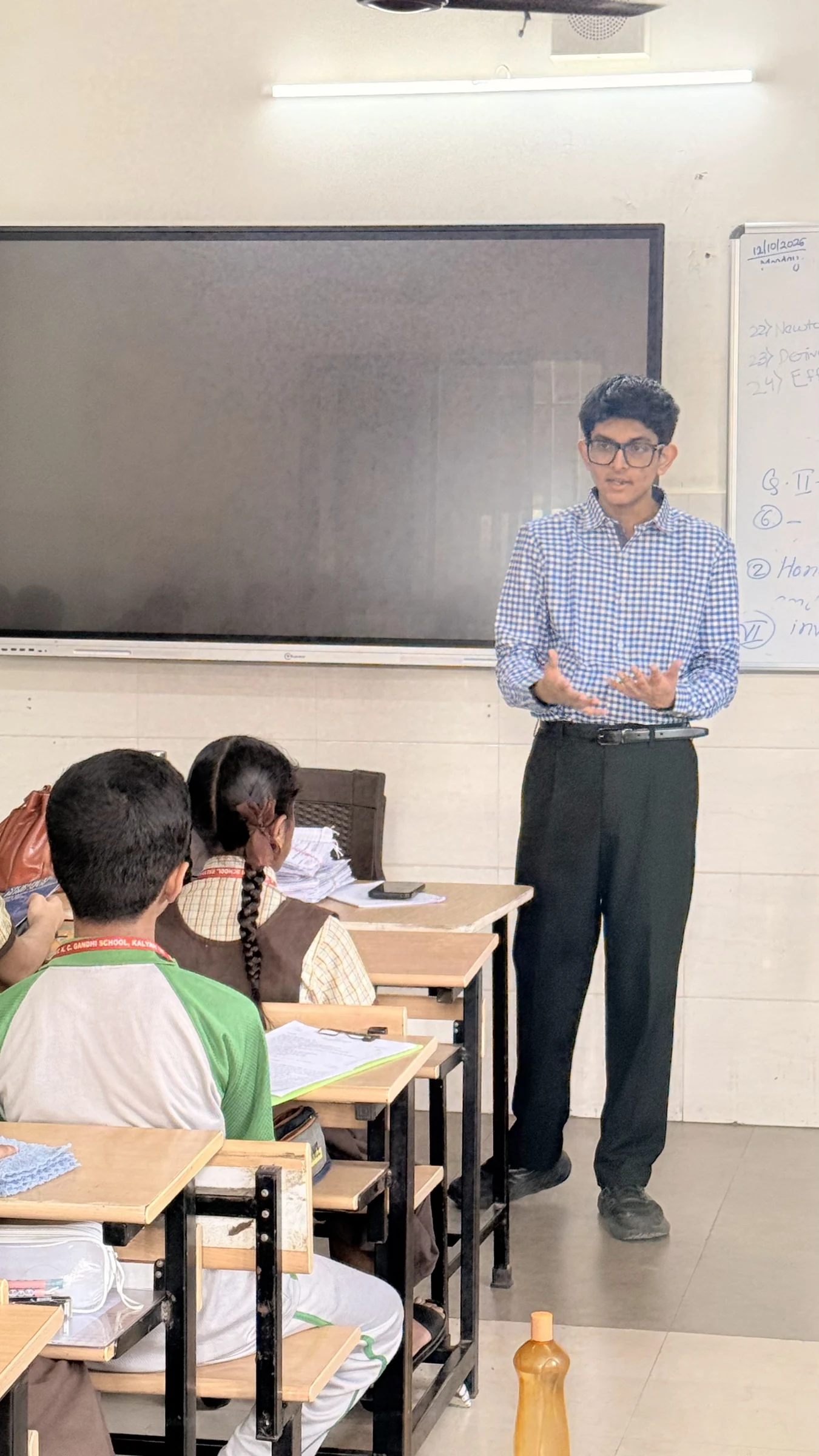 Aarav discussing sustainability with students in their classroom