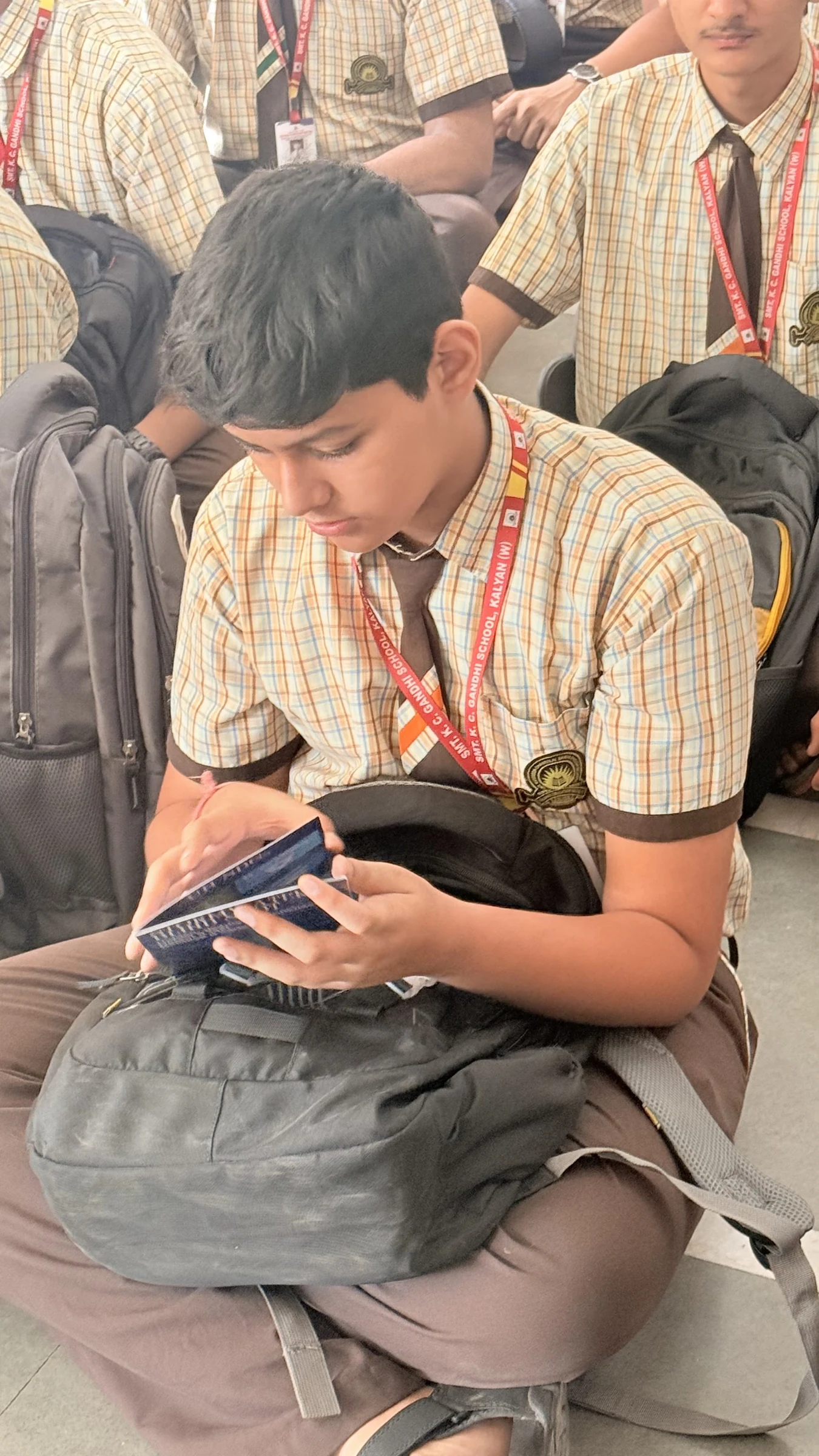 A student reading The Blue Book during a school session