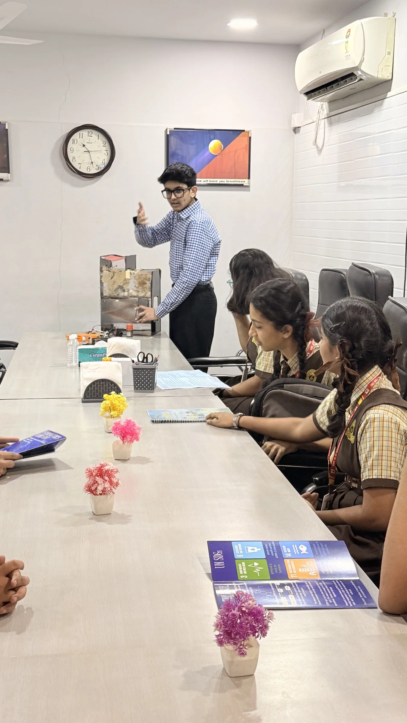 Discussing water science around a table with students