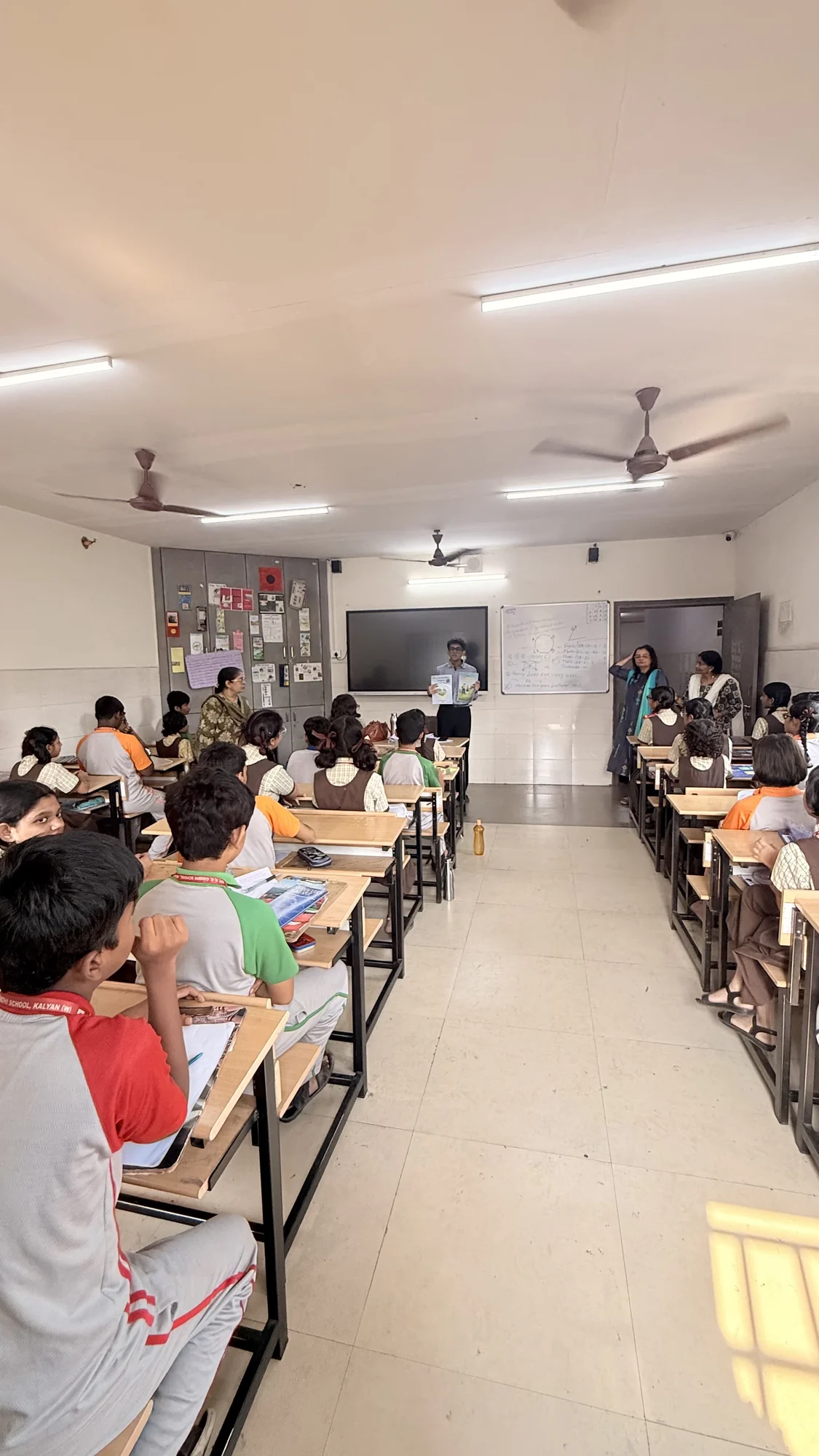 A classroom of students taking part in a school session