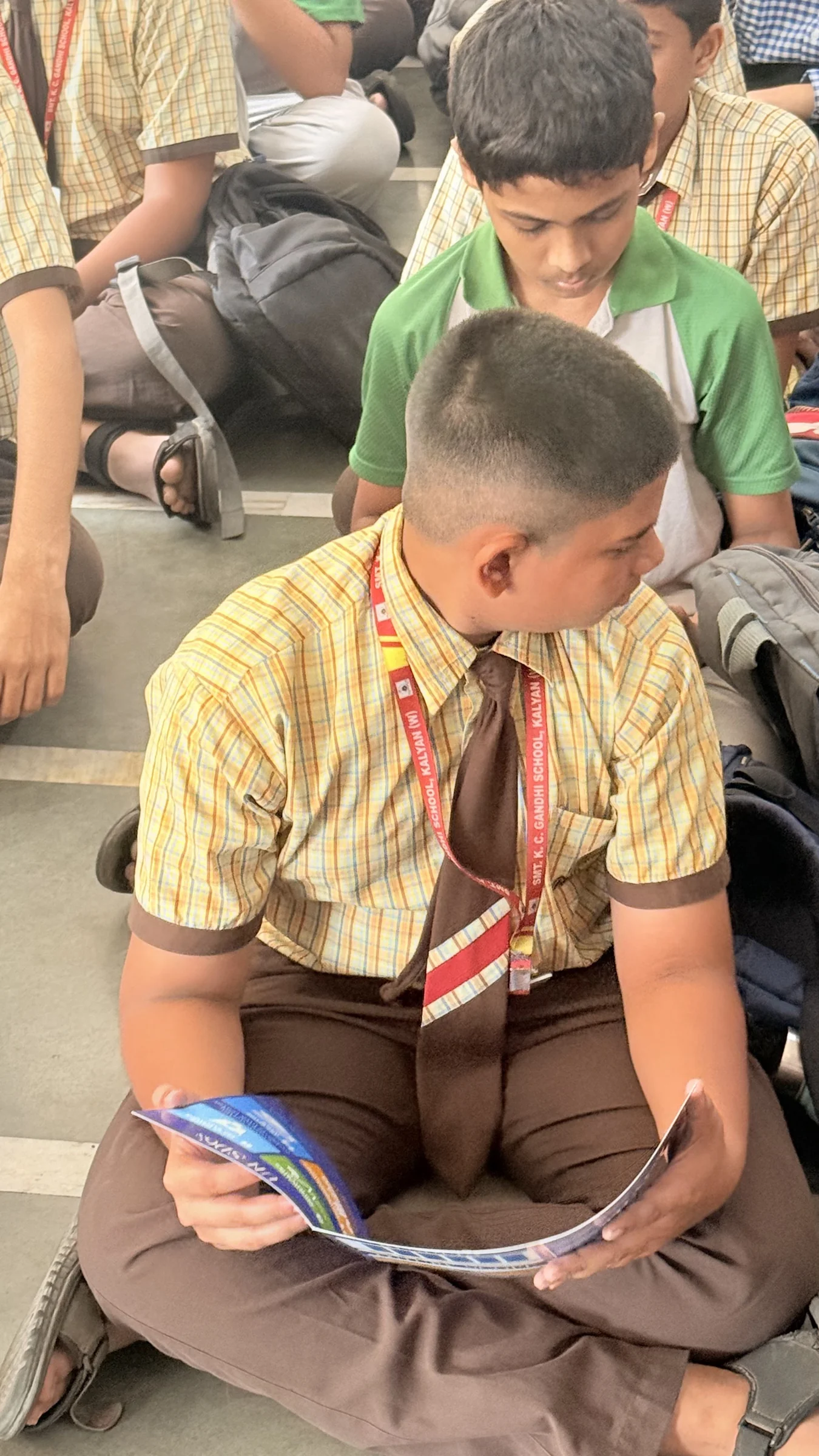 A student reading The Blue Book during a school session