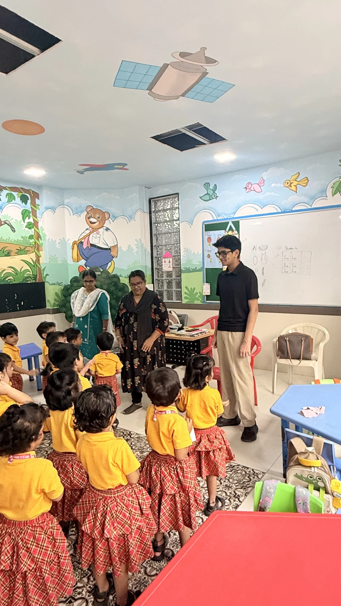 Younger students gathered together for an interactive school session